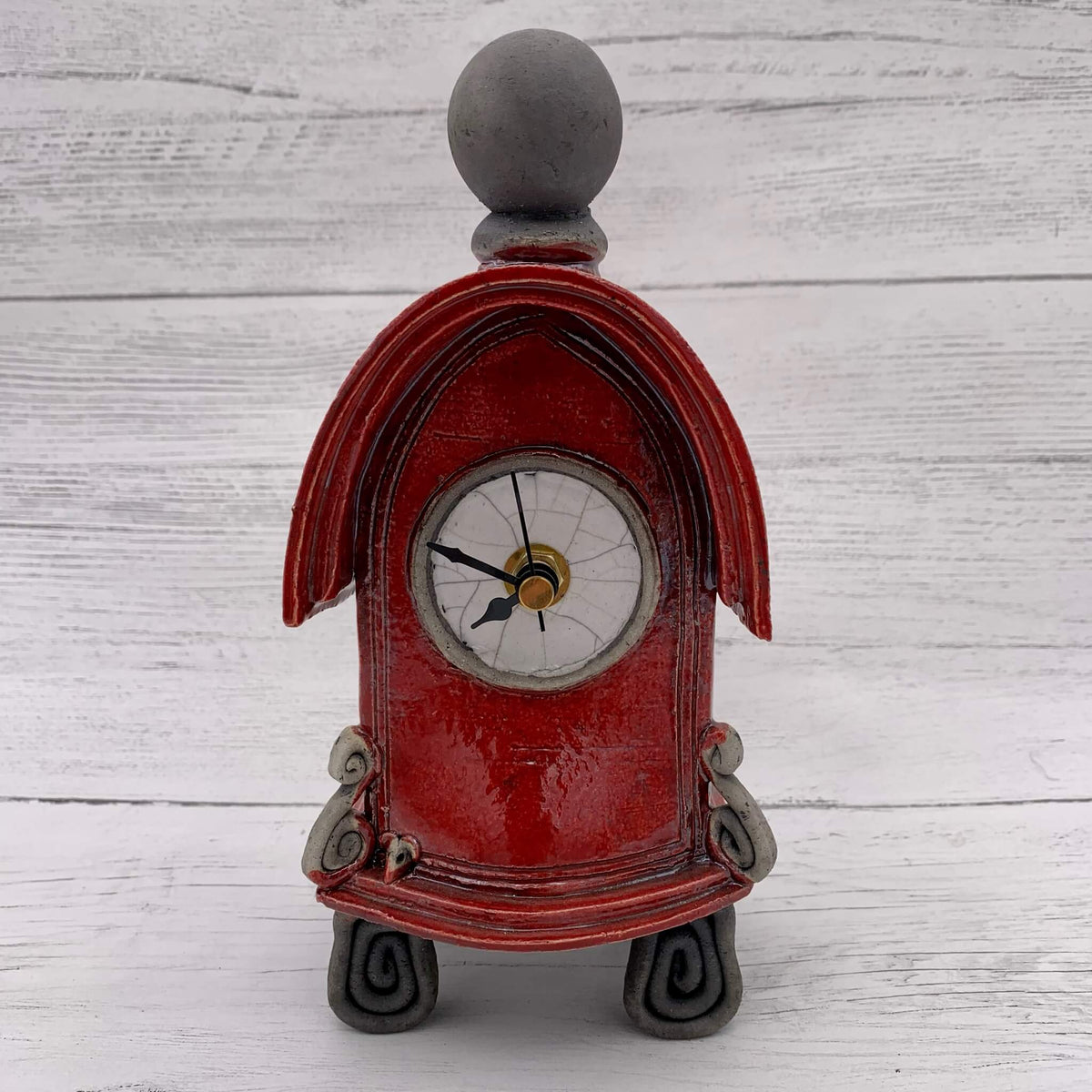 Ceramic raku fired red clock, handmade by stonesplitter in the UK.
