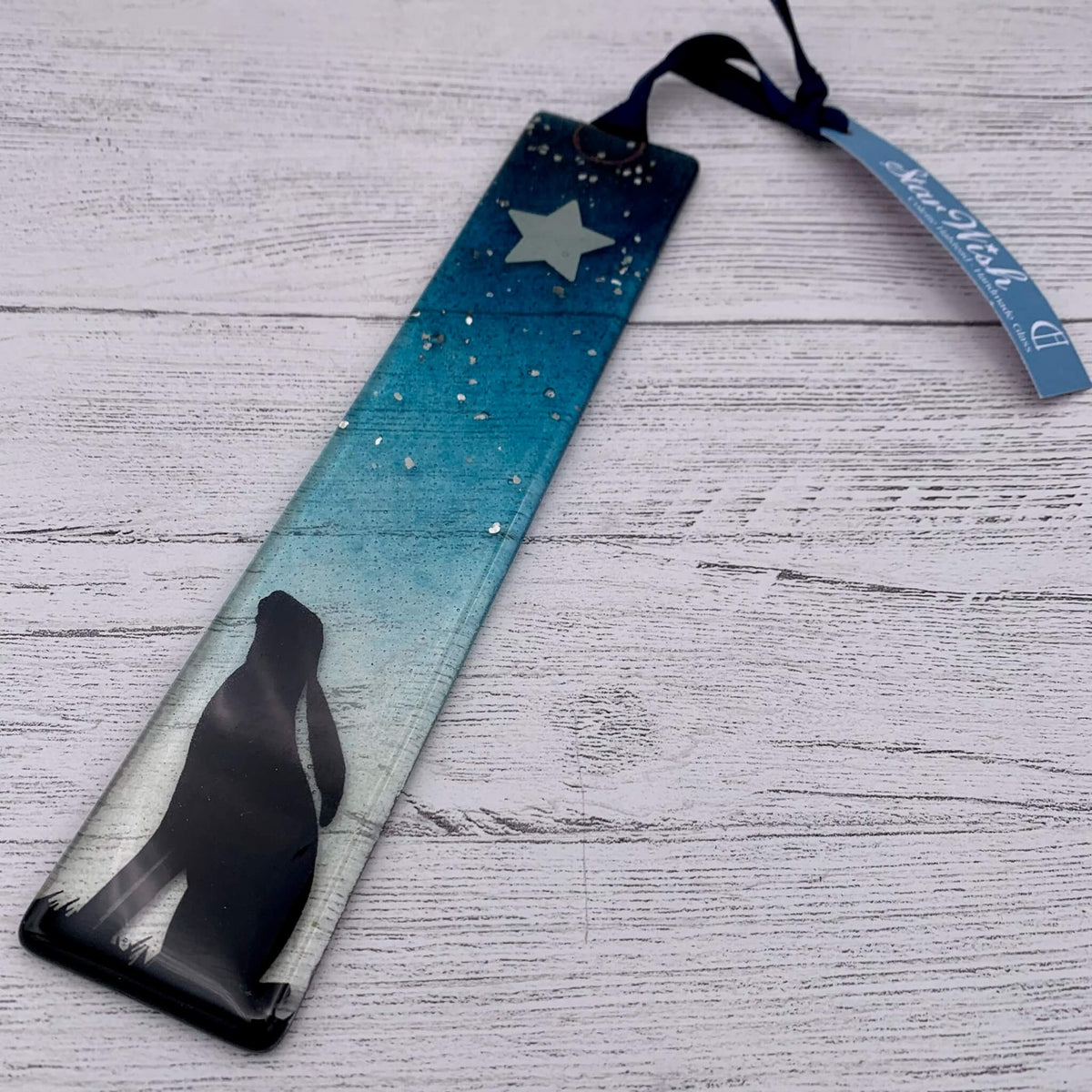Handcrafted blue fused glass wish stick, with a star at the top and glitter.  