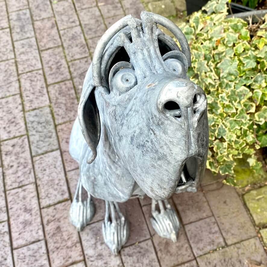 Seated metal dog sculpture, suitable for both outdoor and indoor.