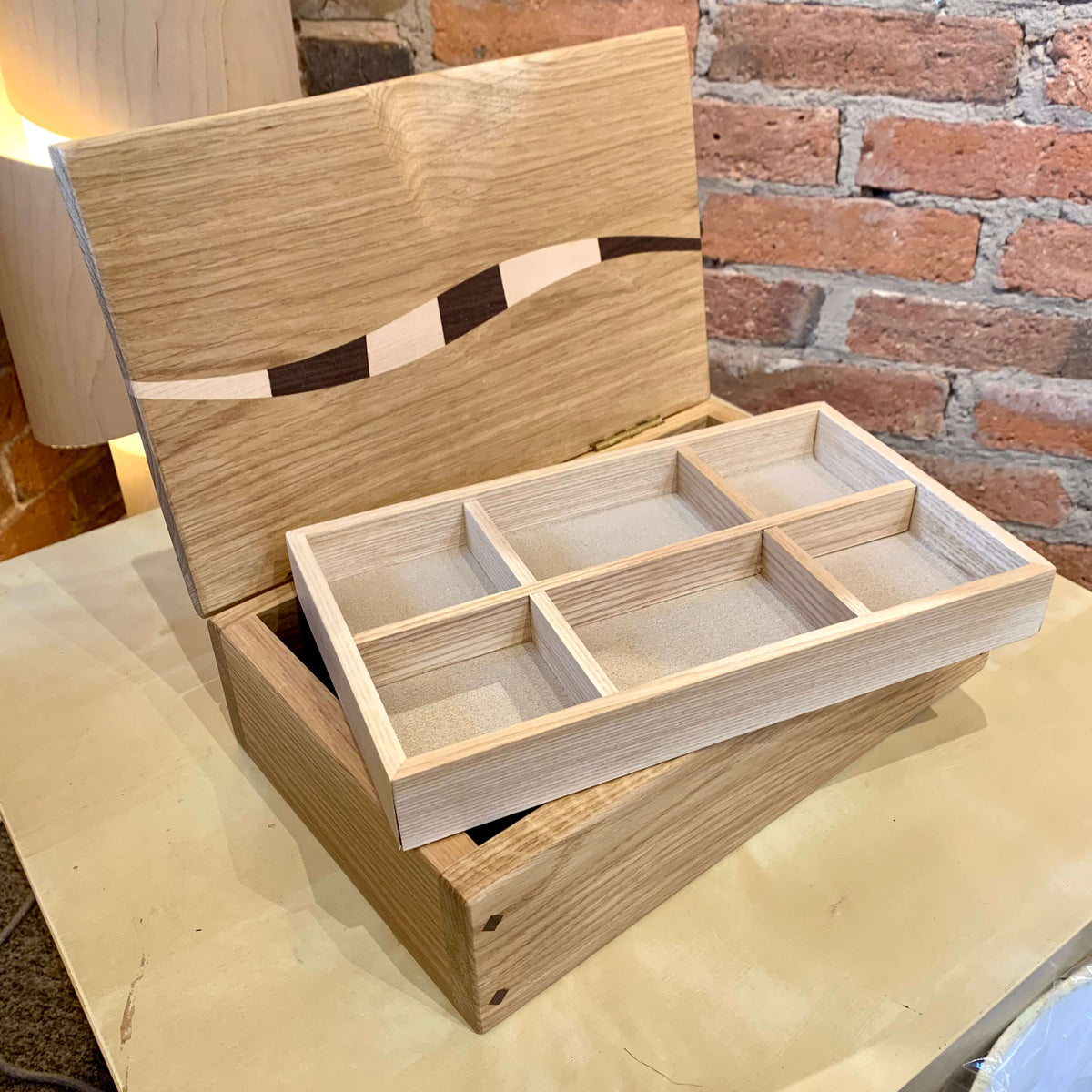 Handmade wooden jewellery box with multiple compartments, available at Ferrers Gallery.