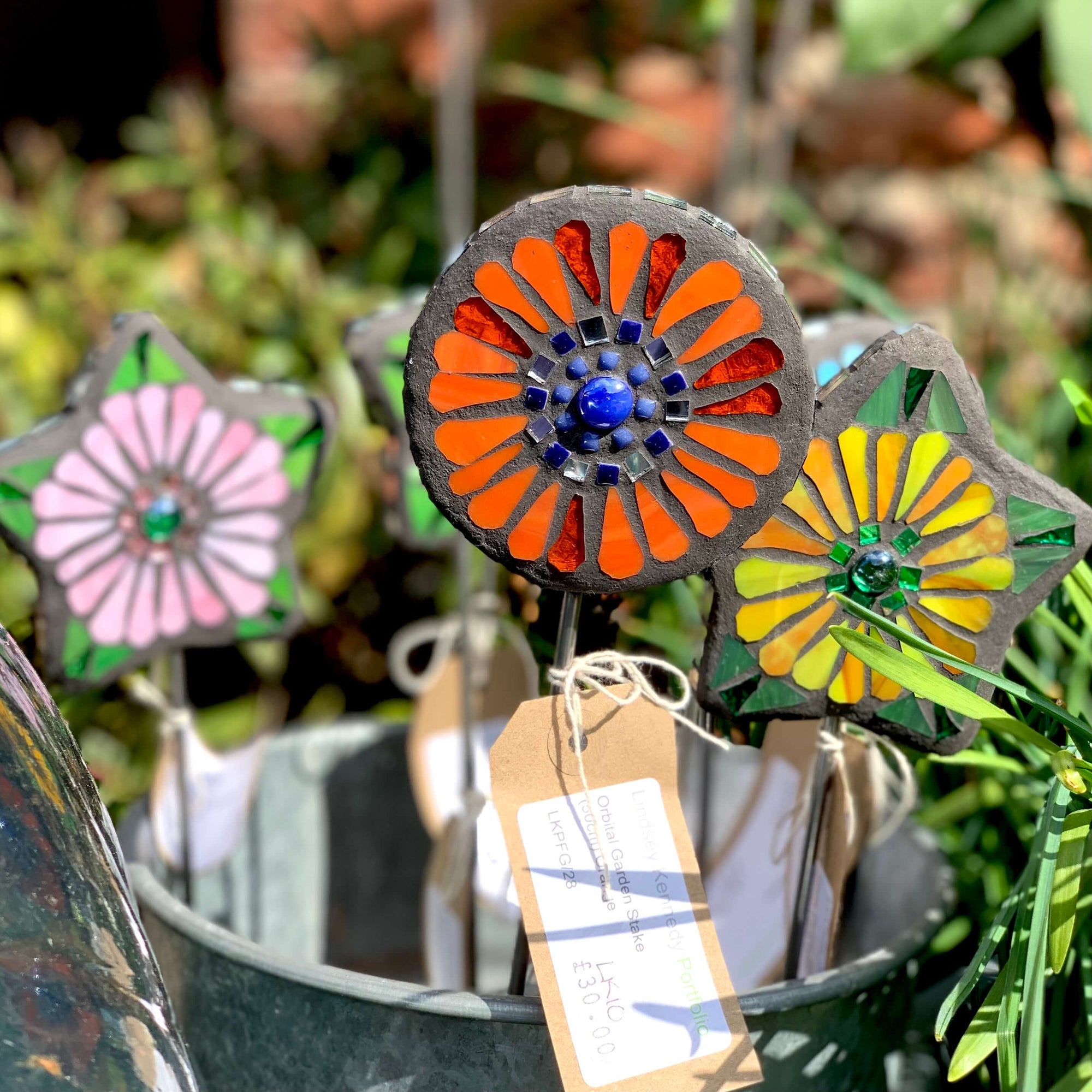 Handmade in the UK, colourful flower shaped mosaic garden stakes.