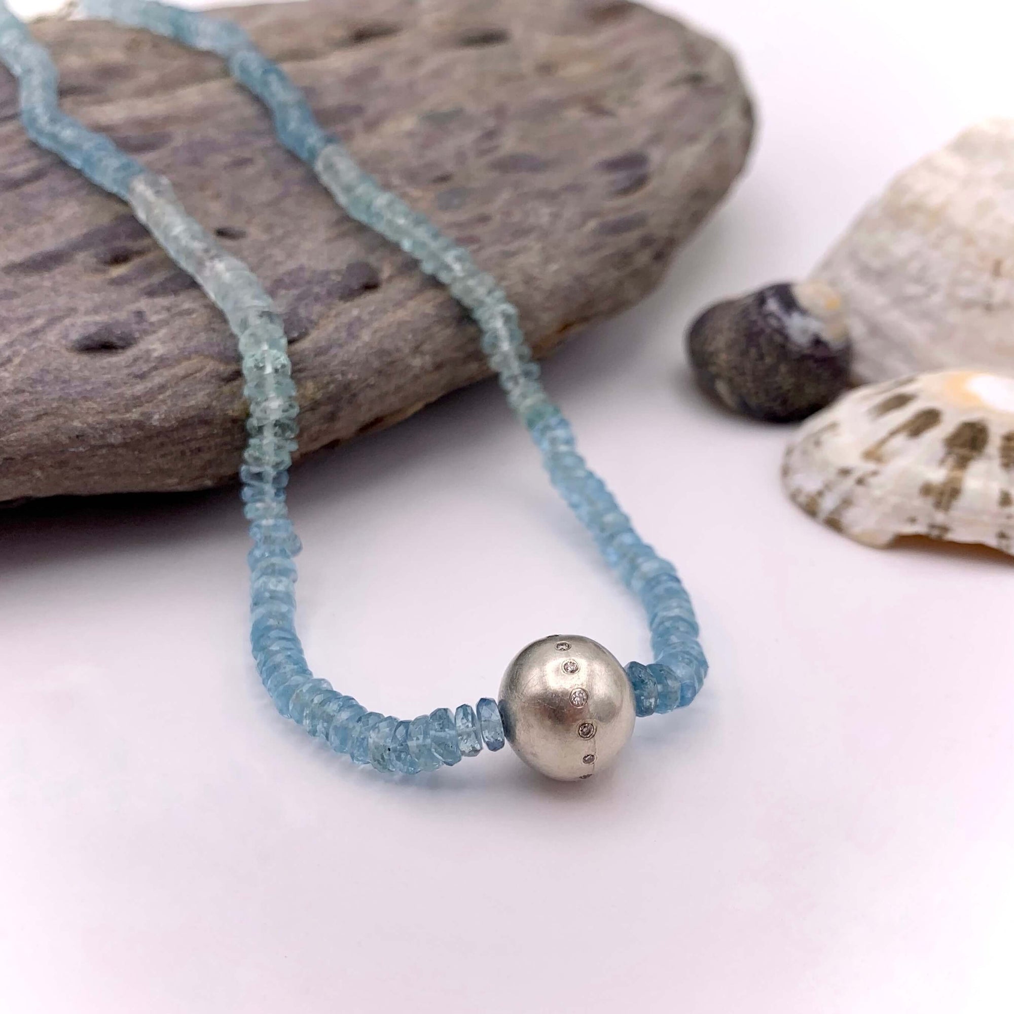Handmade blue semi precious stones necklace, featuring sterling silver ball embedded with diamonds.