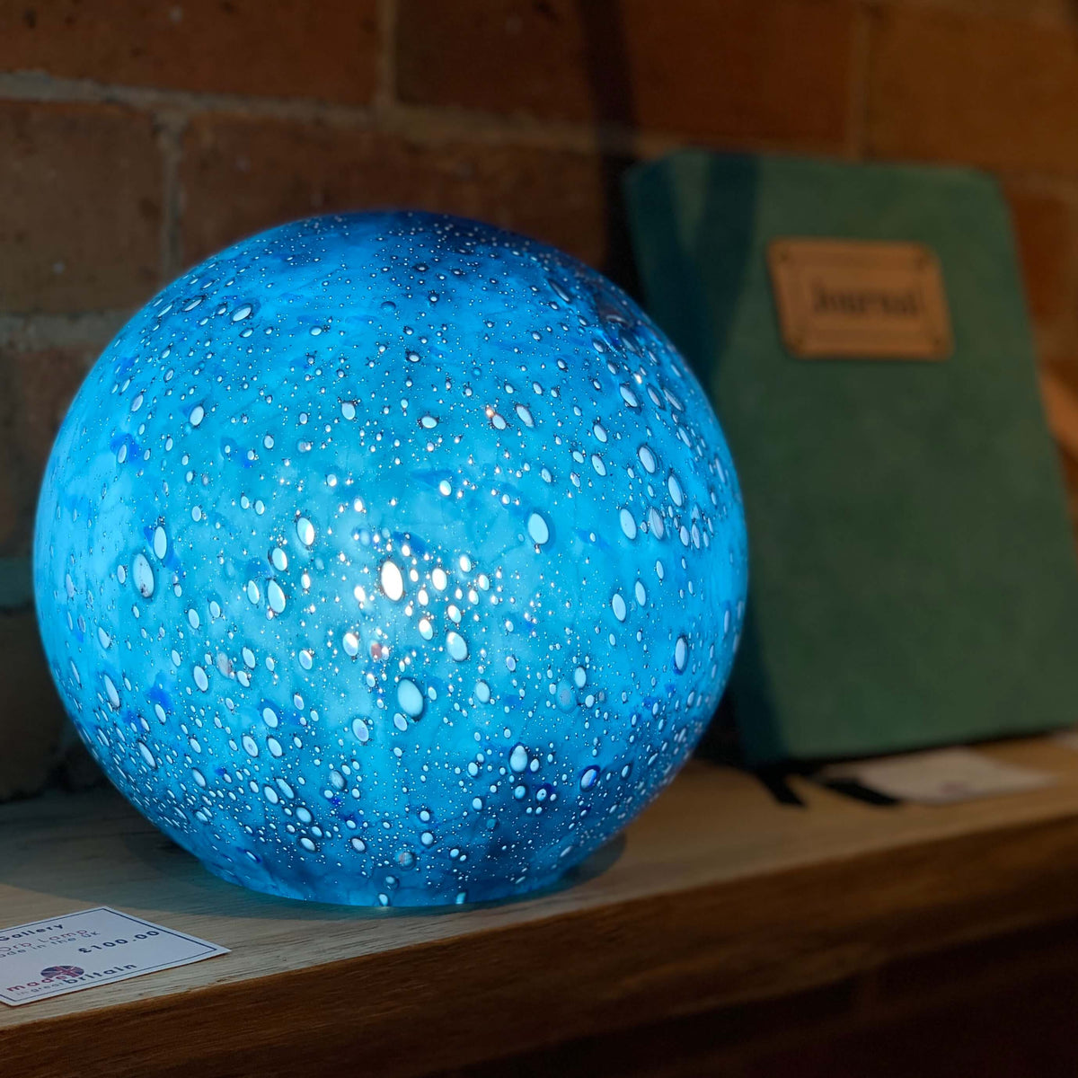Blue blown glass orb lights, handmade with bubble pattern and a smooth surface. Available at Ferrers Gallery.