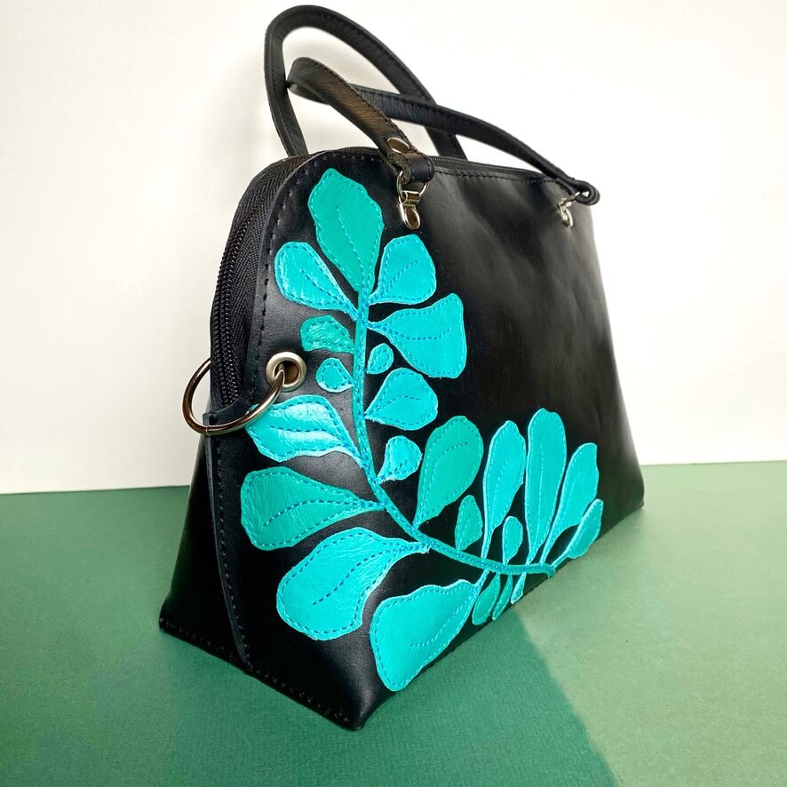 Womens black leather handbag with blue leaf pattern. Handmade in the uk.