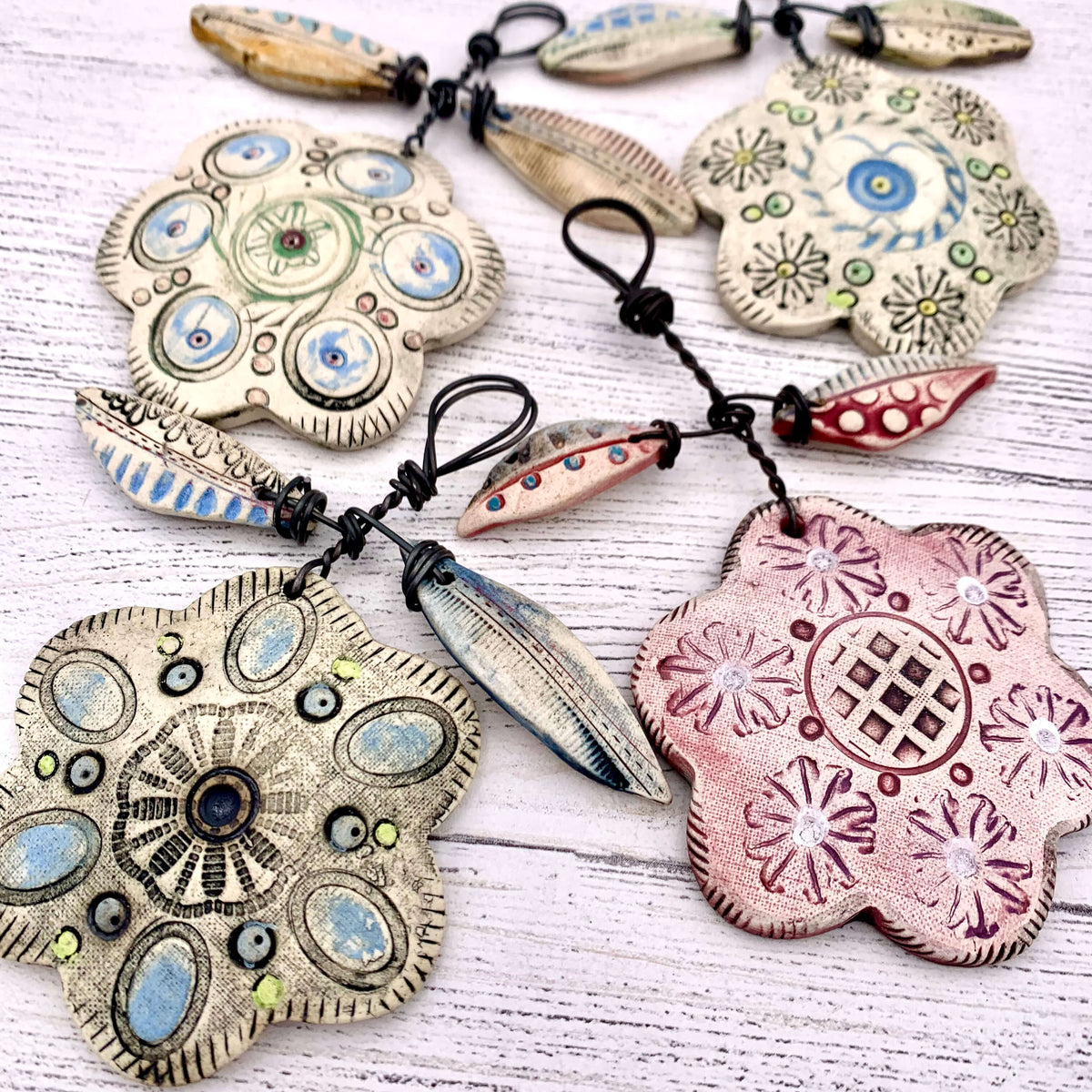 Shirley Vauvelle handmade ceramic flower hanging decorations, made with wire and ceramic.