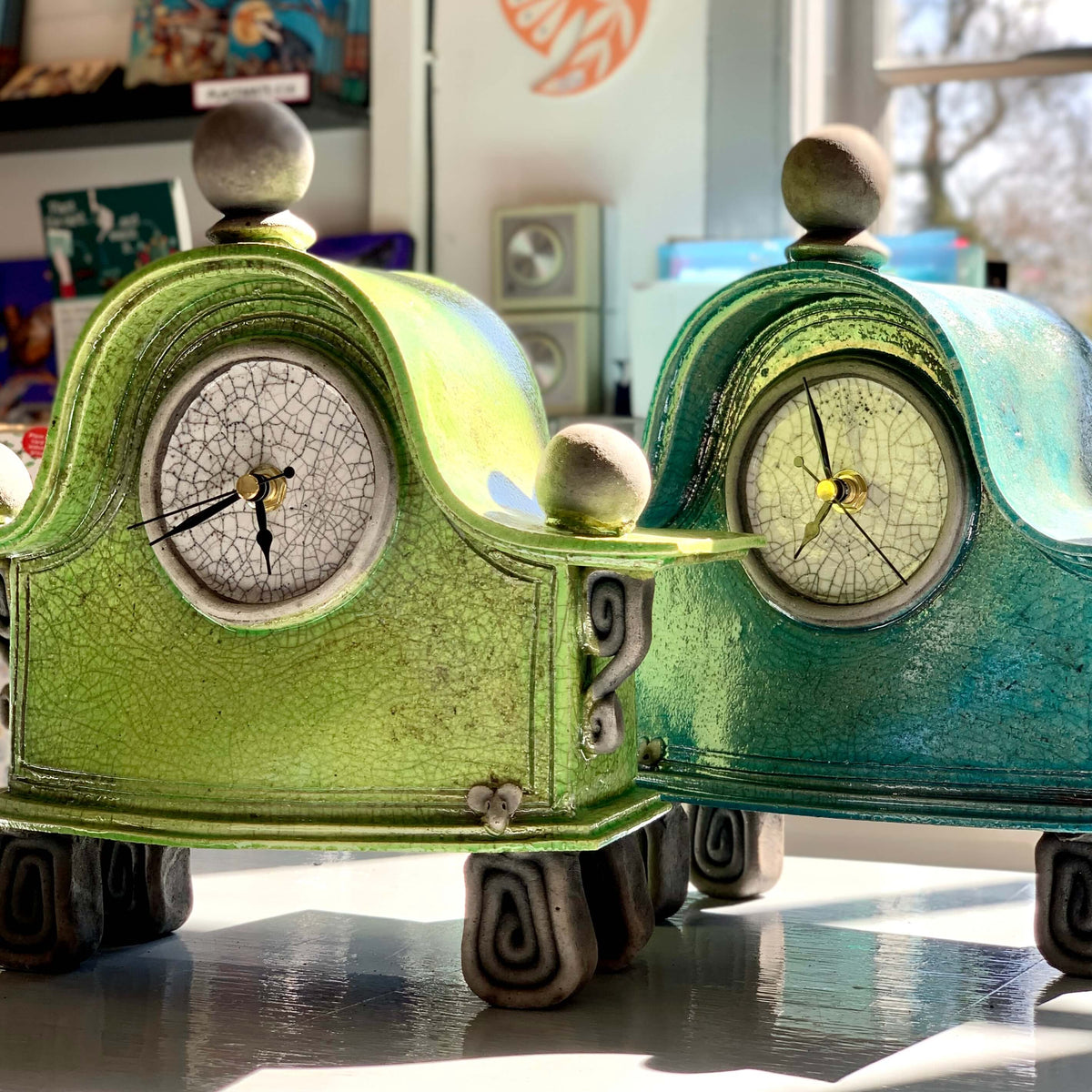 Handcrafted green and turquoise ceramic raku fired clocks, made by stonesplitter in the UK.